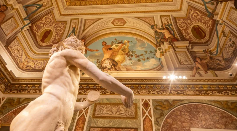 Sculpture under the painted ceiling of Room III, where Bernini's Apollo and Daphne stands
